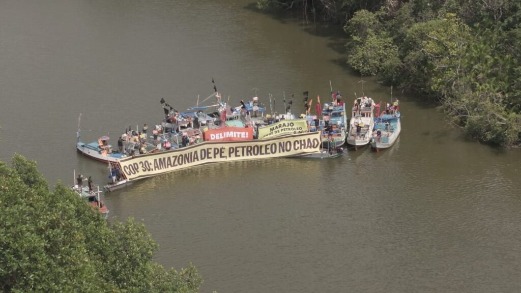 Um conjunto de 16 embarcações formaram uma linha simbólica no rio, exibindo uma faixa com a mensagem: “COP30: Amazônia de pé, petróleo no chão”.